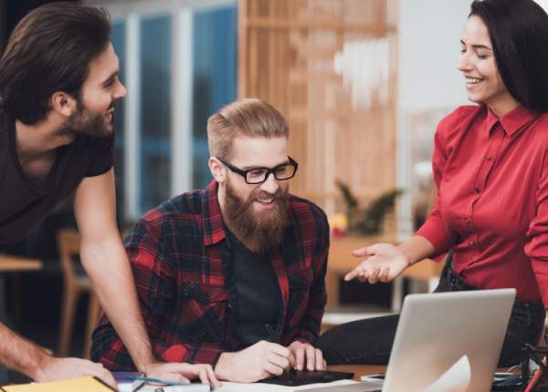 Team collaborating on laptop, building a unified Archestra AI framework.